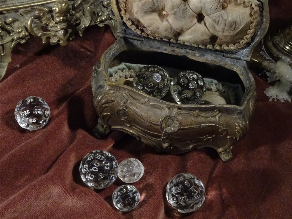 A jewellery casket filled with and surrounded by crystal fortune dice
